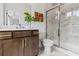 Elegant bathroom with a sliding glass door shower, dark wood vanity, and neutral walls at 2531 Astaire Ct, Atlanta, GA 30318