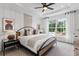 Bright bedroom features a large window, stylish decor, and a ceiling fan at 2531 Astaire Ct, Atlanta, GA 30318