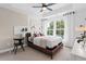 Cozy bedroom with natural light, a ceiling fan, and a decorative seating arrangement at 2531 Astaire Ct, Atlanta, GA 30318