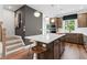 Stylish kitchen with an island, stainless steel appliances and wood cabinets that connects to the staircase at 2531 Astaire Ct, Atlanta, GA 30318
