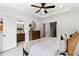 Bright main bedroom featuring a ceiling fan, tray ceiling, and ensuite bathroom access at 2531 Astaire Ct, Atlanta, GA 30318