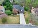 Aerial view of a two-story brick home with a red door and well-manicured lawn at 2739 Springfount Trl, Lawrenceville, GA 30043