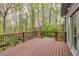 A spacious wooden deck offers a serene view of the lush, wooded backyard at 2739 Springfount Trl, Lawrenceville, GA 30043