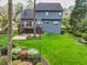 Expansive backyard featuring a deck, patio, lush lawn, and colorful flowerbeds, ideal for outdoor enjoyment at 2739 Springfount Trl, Lawrenceville, GA 30043