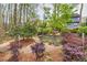 Landscaped backyard featuring a stone path and vibrant foliage, enhancing the natural beauty of the property at 2739 Springfount Trl, Lawrenceville, GA 30043