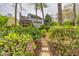 Charming backyard view showcasing the home's exterior and lush landscaping with vibrant flowering bushes at 2739 Springfount Trl, Lawrenceville, GA 30043