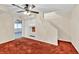 A finished basement with red carpet and built-in shelving near the stairway at 2739 Springfount Trl, Lawrenceville, GA 30043
