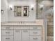 A bathroom features a vanity with white cabinets, and a large mirror with sconces and a glass enclosed shower at 2739 Springfount Trl, Lawrenceville, GA 30043