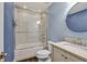 Cozy bathroom with blue walls and a sliding door shower bath at 2739 Springfount Trl, Lawrenceville, GA 30043