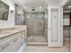 A bathroom features a glass enclosed shower with gray tile surround, vanity, and access to the closet at 2739 Springfount Trl, Lawrenceville, GA 30043