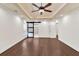 A spacious bedroom with hardwood floors features a ceiling fan and access to the bathroom through a sliding door at 2739 Springfount Trl, Lawrenceville, GA 30043
