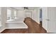 Bonus room featuring hardwood floors, with mirrors in the background, and a bathroom entrance at 2739 Springfount Trl, Lawrenceville, GA 30043