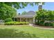 Inviting community clubhouse with a covered porch, surrounded by mature trees and a green lawn at 2739 Springfount Trl, Lawrenceville, GA 30043