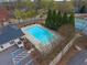 Aerial view of the community pool, complete with lounge chairs, a pool house, and tennis courts at 2739 Springfount Trl, Lawrenceville, GA 30043