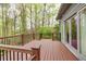 The deck features wood flooring, dark wood railings, and french doors leading inside the home at 2739 Springfount Trl, Lawrenceville, GA 30043