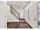 Bright entryway with hardwood floors, a staircase with a wooden railing, and a decorative front door at 2739 Springfount Trl, Lawrenceville, GA 30043