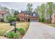 Attractive brick home with a lush green lawn and a long driveway leading to an attached garage at 2739 Springfount Trl, Lawrenceville, GA 30043