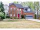 Charming two-story brick home with a well-manicured lawn and a bright red front door at 2739 Springfount Trl, Lawrenceville, GA 30043