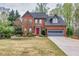 Beautiful two-story brick home with a well-manicured lawn, red front door, and attached two-car garage at 2739 Springfount Trl, Lawrenceville, GA 30043
