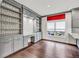 Bright kitchen area featuring gray cabinetry, built-in shelving, hardwood floors, and a dedicated desk space at 2739 Springfount Trl, Lawrenceville, GA 30043