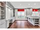 Open concept kitchen with gray cabinetry, granite countertops, hardwood floors, and built-in desk area at 2739 Springfount Trl, Lawrenceville, GA 30043