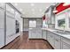 Spacious kitchen featuring gray cabinets, built-in shelving, stainless steel appliances, and hardwood floors at 2739 Springfount Trl, Lawrenceville, GA 30043