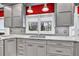Modern kitchen featuring gray cabinets, granite countertops, stainless steel fixtures, and hardwood flooring at 2739 Springfount Trl, Lawrenceville, GA 30043