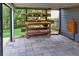 A covered patio area featuring a wooden potting table with flowers in decorative pots at 2739 Springfount Trl, Lawrenceville, GA 30043