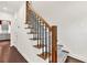 Carpeted staircase with elegant wooden railings and wrought iron spindles at 2739 Springfount Trl, Lawrenceville, GA 30043