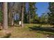 Spacious backyard with storage shed surrounded by mature trees, offering ample space at 3095 Meadow Lark Ln, Atlanta, GA 30344