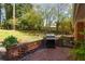 Backyard patio area with brick accents and lush greenery at 3095 Meadow Lark Ln, Atlanta, GA 30344