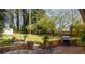 Spacious backyard patio area with grill and green lawn at 3095 Meadow Lark Ln, Atlanta, GA 30344