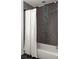 Bathroom with neutral tile, sleek fixtures, and a shower with a decorative tiled stripe for a modern aesthetic at 3095 Meadow Lark Ln, Atlanta, GA 30344