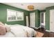 Inviting bedroom bathed in natural light featuring hardwood floors, a large mirror, and stylish decor at 3095 Meadow Lark Ln, Atlanta, GA 30344