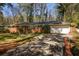 Charming brick home with well-manicured lawn, mature trees, and a two-car garage at 3095 Meadow Lark Ln, Atlanta, GA 30344