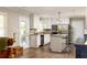 Bright kitchen with white cabinets, stainless steel appliances, granite counters, and a chic island with stool seating at 3095 Meadow Lark Ln, Atlanta, GA 30344