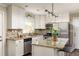 Updated kitchen featuring white cabinetry, stainless steel appliances, and a granite countertop island with breakfast bar at 3095 Meadow Lark Ln, Atlanta, GA 30344