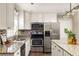 Modern kitchen featuring stainless appliances, granite countertops, and stylish light fixtures for a contemporary feel at 3095 Meadow Lark Ln, Atlanta, GA 30344