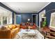 Cozy living room featuring a blue front door and hardwood floors at 3095 Meadow Lark Ln, Atlanta, GA 30344