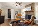 Cozy living room featuring hardwood floors, a stone fireplace, and a comfortable leather chair with ottoman at 3095 Meadow Lark Ln, Atlanta, GA 30344