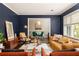 Stylish living room with navy walls, hardwood floors, and modern furniture at 3095 Meadow Lark Ln, Atlanta, GA 30344