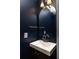 Modern powder room with a dark blue walls and updated fixtures over a floating vanity for a sleek design at 3095 Meadow Lark Ln, Atlanta, GA 30344