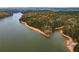 Aerial view of the lake with a sandy beach and forested landscape at 328 Allatoona Shores Dr, Canton, GA 30114