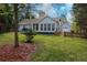 A view of the backyard with a detached garage and a screened-in porch at 328 Allatoona Shores Dr, Canton, GA 30114