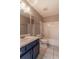 Bathroom featuring blue vanity and white tile tub surround at 328 Allatoona Shores Dr, Canton, GA 30114