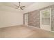 Spacious bedroom with stone accent wall, neutral carpet, ceiling fan and natural light at 328 Allatoona Shores Dr, Canton, GA 30114