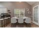 Dining area featuring a marble table, modern white chairs, and barstool seating at the kitchen counter at 328 Allatoona Shores Dr, Canton, GA 30114