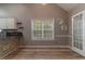 Charming kitchenette featuring stone accents, white cabinets, and wood-look flooring at 328 Allatoona Shores Dr, Canton, GA 30114