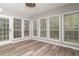 Bright sunroom with many windows and wood-look flooring, and an exterior access door at 328 Allatoona Shores Dr, Canton, GA 30114