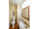 Half bathroom with modern fixtures, granite countertop, and decorative mirror at 3729 Town Square Nw Cir # 6, Kennesaw, GA 30144